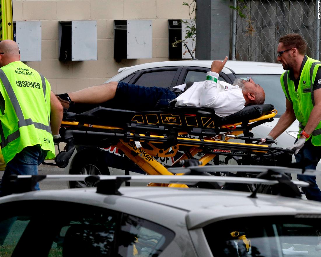 Paramedics load an injured man into an ambulance in Christchurch, New Zealand, on Friday, March 15.