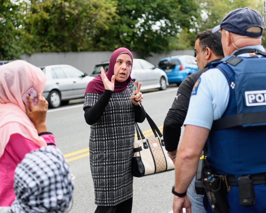 Members of the public react in front of the al Noor mosque after the attack.