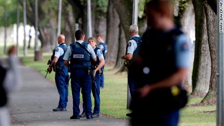 Police keep watch at a park near one of the mosques attacked on Friday.