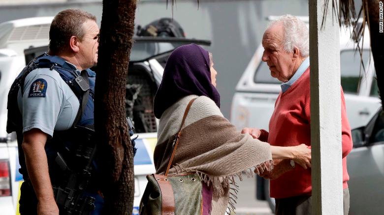 Police escort people away from outside a mosque in central Christchurch after the shootings.