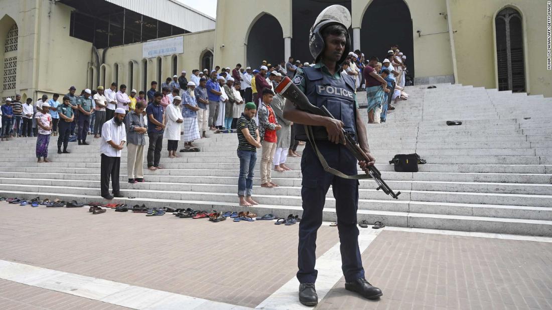 A police officer stands guard as Muslims pray in Dhaka, Bangladesh, on March 15.