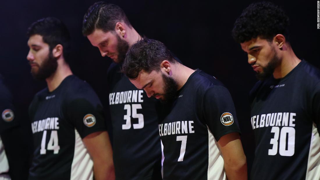 Players from the Australian basketball team Melbourne United observe a moment of silence before a game in Perth, Australia, on March 15.