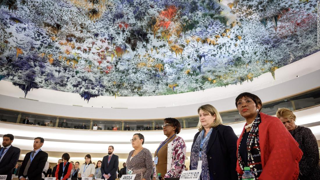 Delegates stand during a minute of silence that was observed at the United Nations Human Rights Council in Geneva, Switzerland.