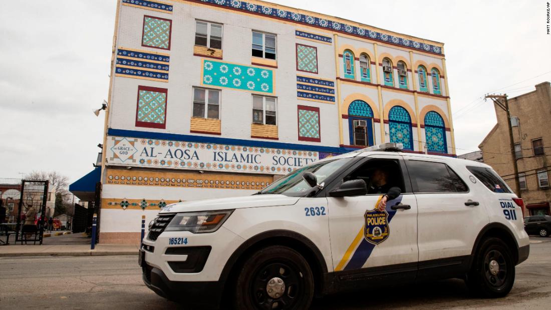 Police officers sit in their vehicle outside the Al Aqsa Islamic Society mosque in Philadelphia on March 15. Many cities bumped up their police presence outside of mosques.