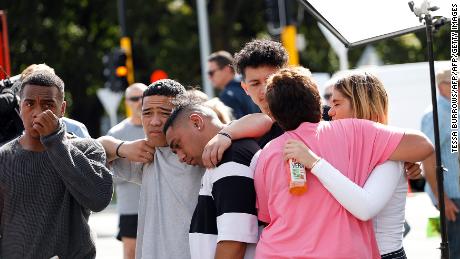 Residents get emotional as they pay respect by placing flowers for the victims of the mosques attacks in Christchurch on March 16, 2019. - New Zealand&#39;s prime minister vowed to toughen the country&#39;s gun laws after revealing Saturday that the man accused of murdering 49 people in two mosques legally purchased the arsenal of firearms used in the massacre. Jacinda Ardern said the gunman, 28-year-old Australian Brenton Tarrant, obtained a &quot;Category A&quot; gun licence in November 2017 and began purchasing the five weapons used in Friday&#39;s attacks in the southern city of Christchurch the following month. (Photo by Tessa BURROWS / AFP)        (Photo credit should read TESSA BURROWS/AFP/Getty Images)