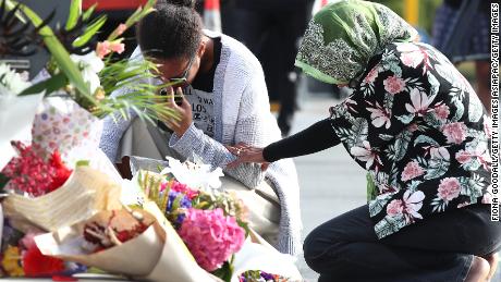 Locals lay flowers in tribute to those killed and injured at Deans Avenue near the Al Noor Mosque in Christchurch, New Zealand.