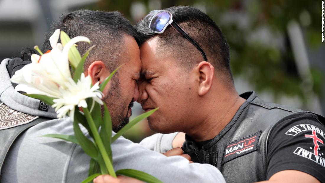 People mourn March 16 at Hagley College in Christchurch.