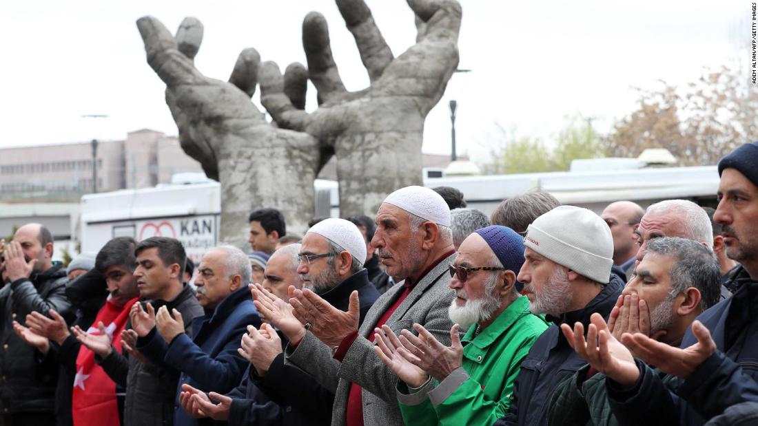 People perform a funeral prayer in absentia on March 16 in Ankara, Turkey. 