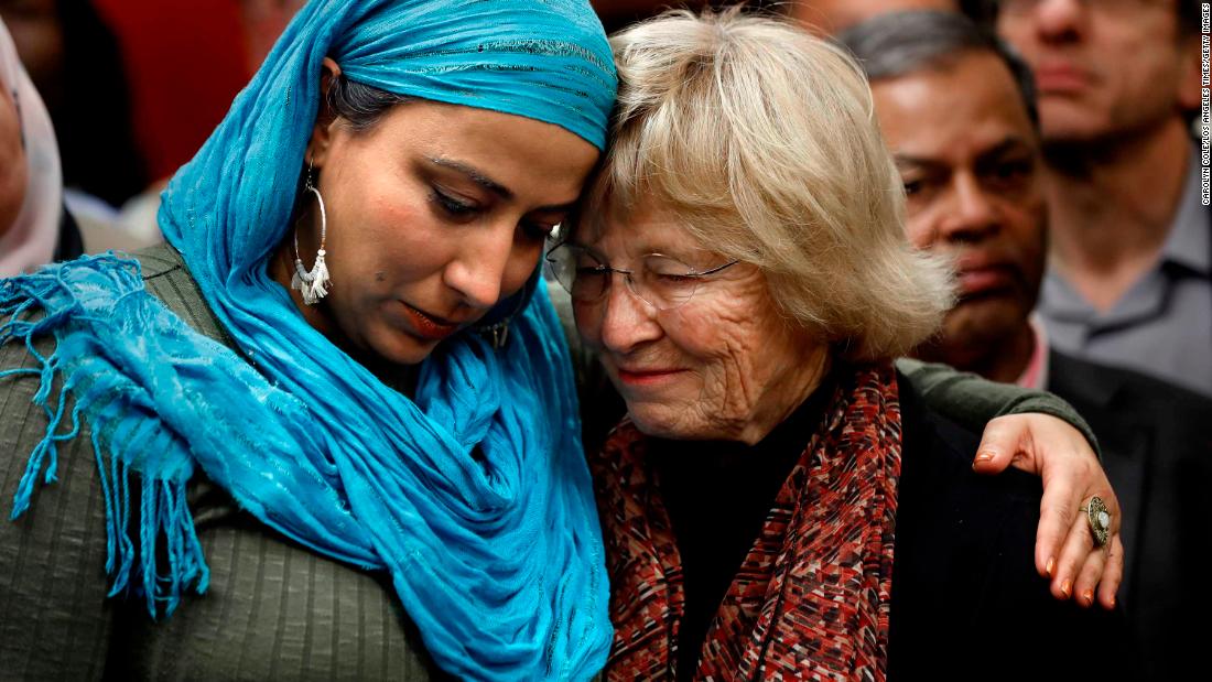 Najeeba Syeed, left, hugs Judy Gilliland at the Islamic Center of Southern California in Los Angeles, where people of all faiths came together in prayer March 16.