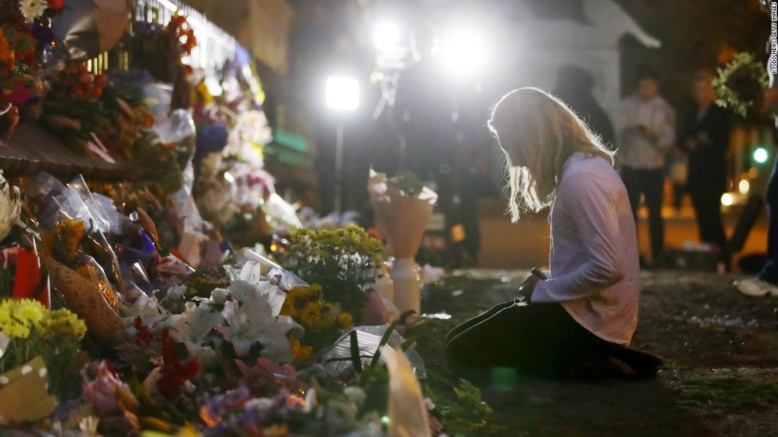 A woman visits a makeshift memorial in Christchurch.