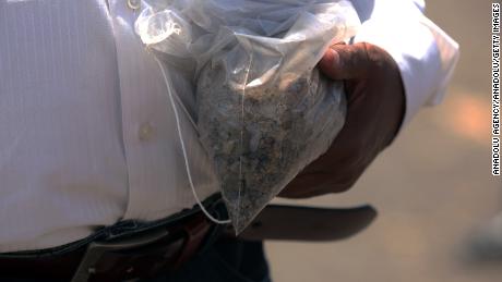 A relative of a victim of the Ethiopian Airlines crash carries soil from the crash site in a bag in Addis Ababa, Ethiopia.