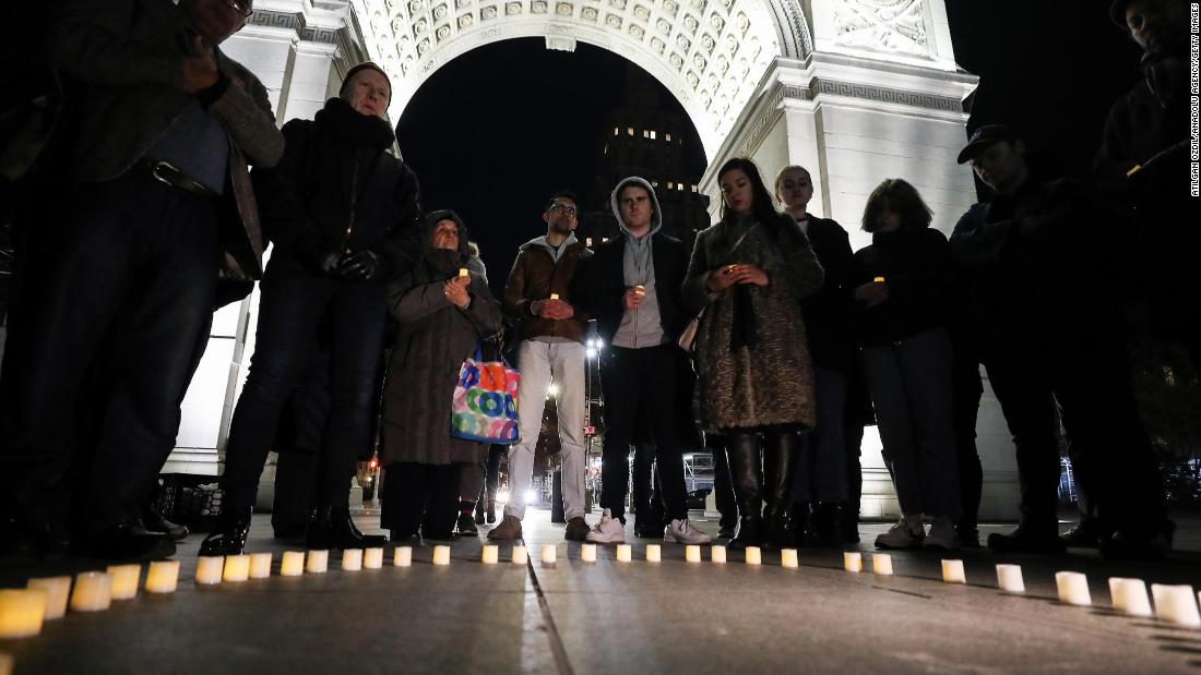 People hold a vigil at Washington Square Park in New York on March 16.