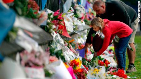 Mourners lay flowers on a wall at the Botanical Gardens in Christchurch on Saturday.