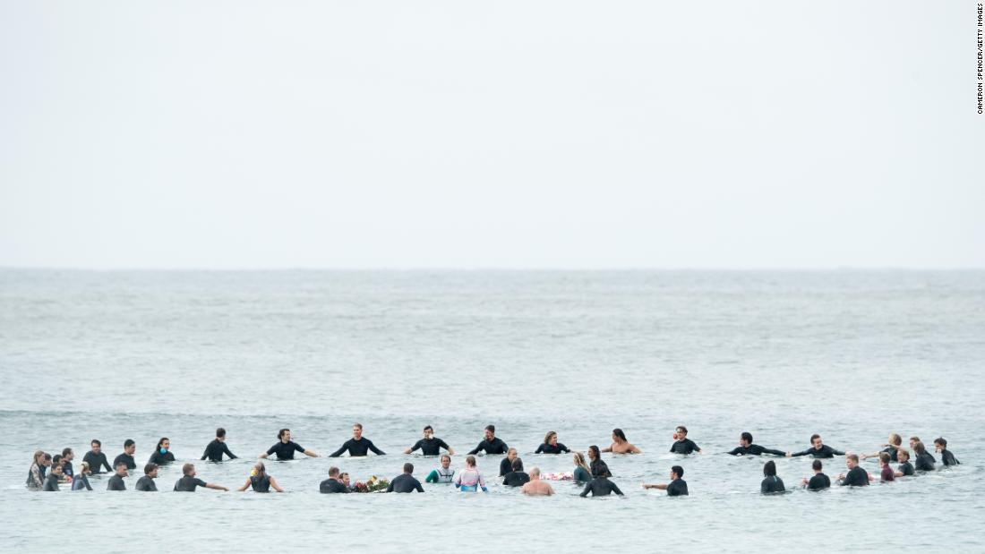 Local surfers and surfers competing in the Sydney Surf Pro participate in a paddle-out, wreath laying and observe a minute of silence to remember victims of the Christchurch mosque attacks at Manly Beach on March 17 in Sydney, Australia.