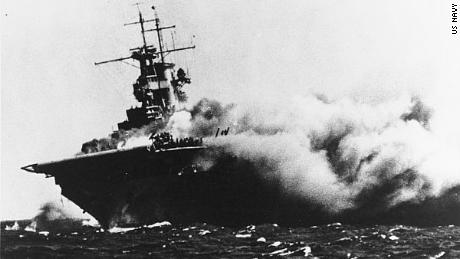 The USS Wasp tilts heavily after a Japanese torpedo strike set the hull ablaze.