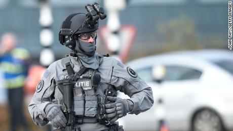 A member of Dutch special police forces patrols the area near the shooting.