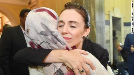 Prime Minister Jacinda Ardern embraces a woman who attended the House session at Parliament on March 19.