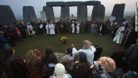 Druids wait for the sun to rise as they celebrate the spring equinox at Stonehenge. 