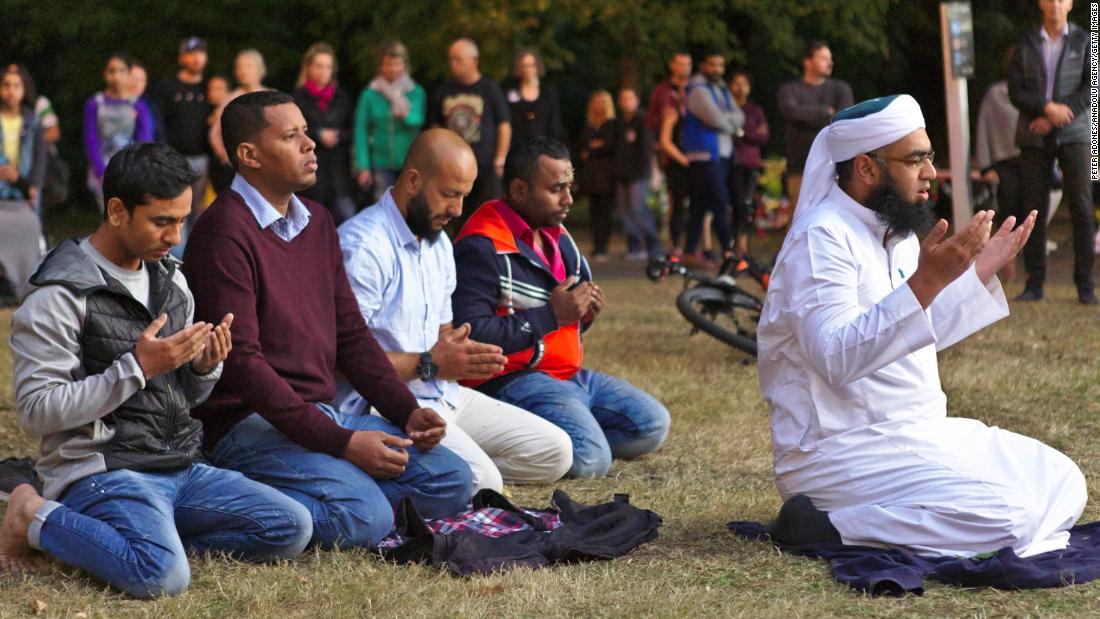 Mufti Zeeyad Ravat, right, a Muslim leader from Melbourne, leads a prayer at the Deans Avenue memorial, near the Al Noor mosque in Christchurch, New Zealand, on Tuesday, March 19.