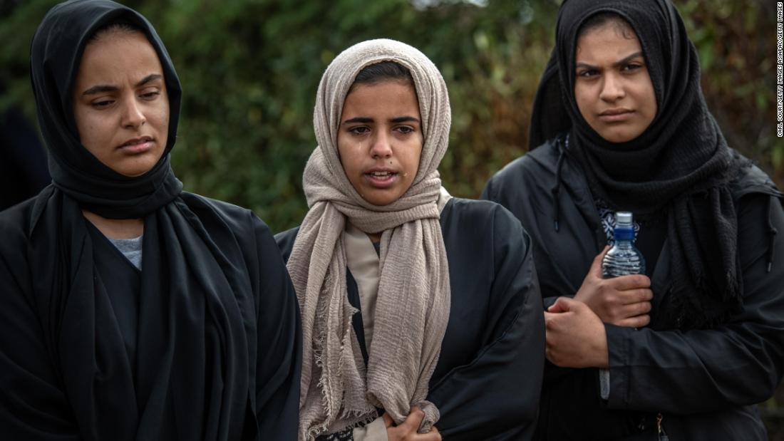 Women mourn at Memorial Park Cemetery on March 20 after attending the funerals of two victims of the Christchurch terrorist attack.