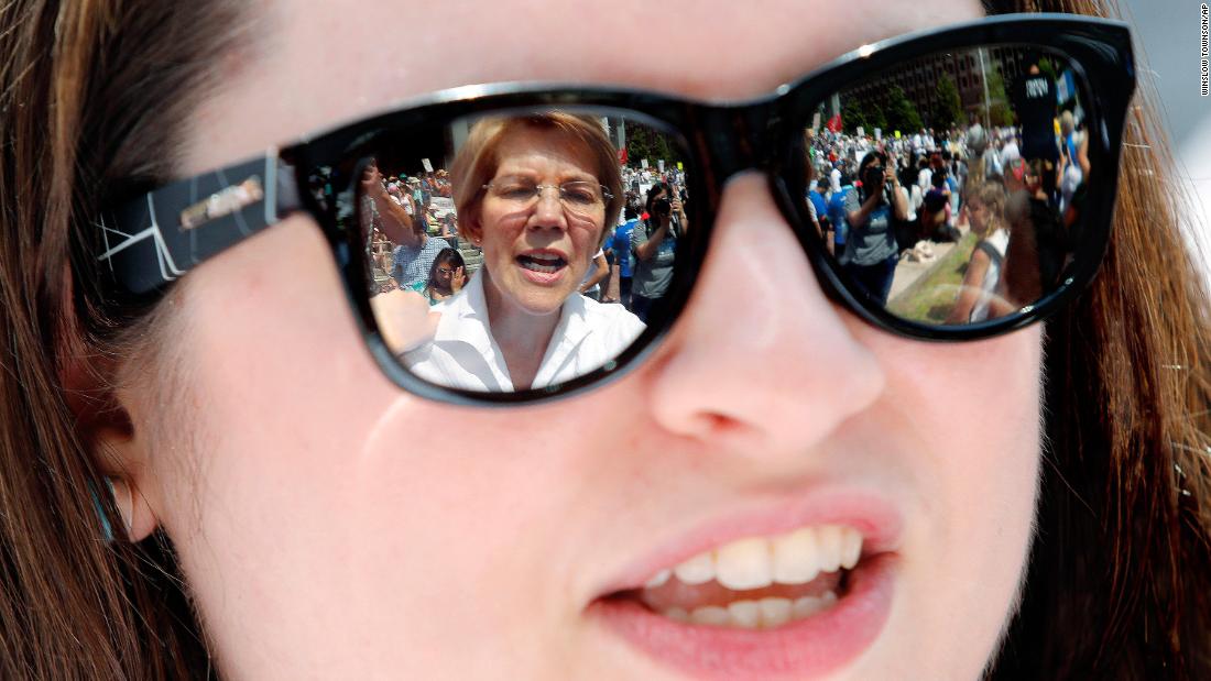 Warren is seen in the sunglasses of Arian Rustemi during a rally in Boston in June 2018. Warren was calling for the swift reunification of children and parents who had been separated at the US-Mexico border.