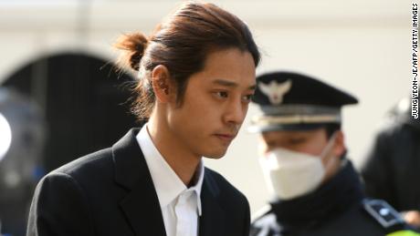K-pop star Jung Joon-young (C) arrives for questioning at the Seoul Metropolitan Police Agency in Seoul on March 14, 2019. - A burgeoning K-pop sex scandal claimed a second scalp as a singer who rose to fame after coming second in one of South Korea&#39;s top talent shows admitted secretly filming himself having sex and sharing the footage. Jung Joon-young, 30, announced his immediate retirement from showbusiness amid allegations he shot and shared sexual imagery without his partners&#39; consent. (Photo by JUNG Yeon-Je / AFP)        (Photo credit should read JUNG YEON-JE/AFP/Getty Images)