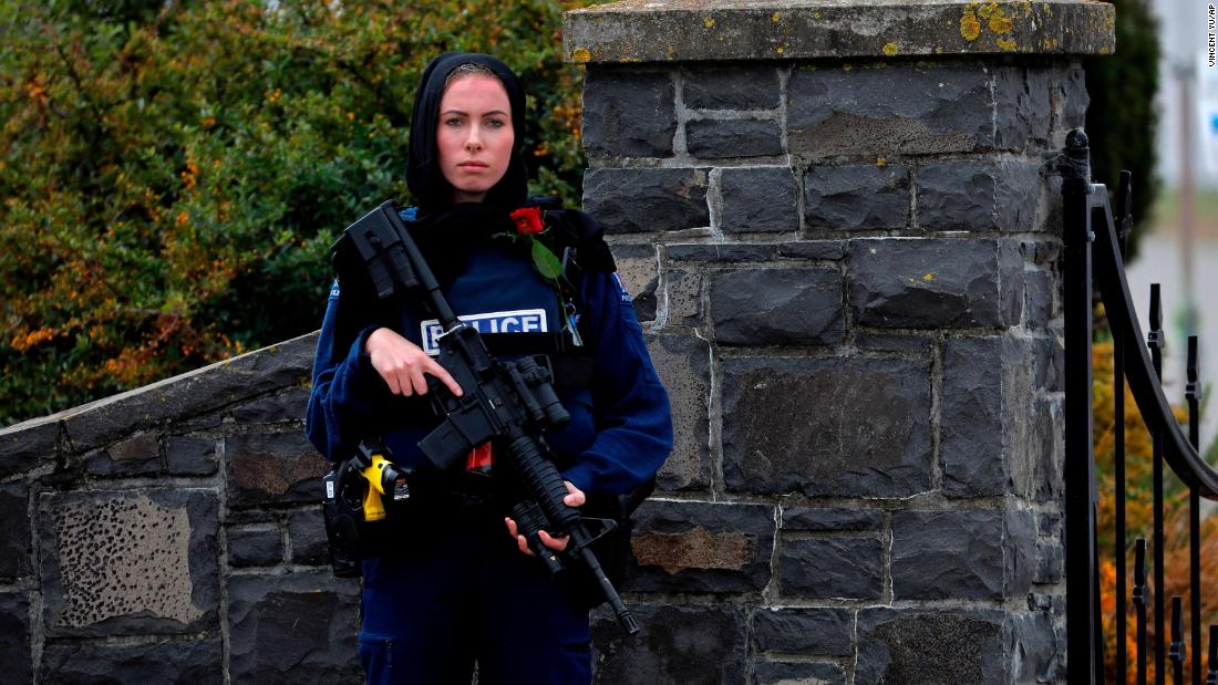 A police officer stands guard at the burial service for a victim of the mosque shootings in Christchurch, New Zealand. 