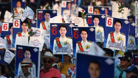 Supporters of the Phalang Pracharat party hold placards in support of their candidates during a campaign rally in Chonburi province on March 21, 2019.