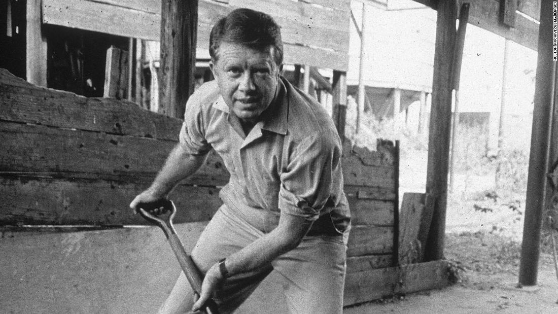 Carter shovels peanuts in the 1970s. Carter was the son of a peanut farmer, and he took over the family business in 1953 before his political career took off.