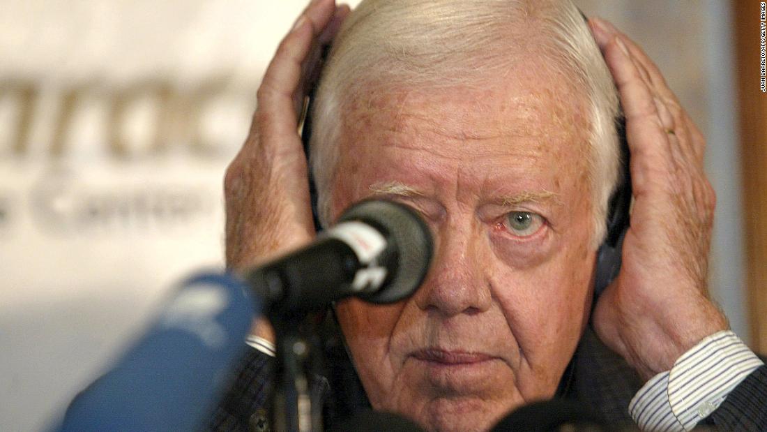 Carter adjusts his headphones at a news conference in Caracas, Venezuela, in January 2003. He proposed a referendum on Venezuelan President Hugo Chavez&#39;s presidency or an amendment to the constitution as a way to end the political crisis in the South American nation.