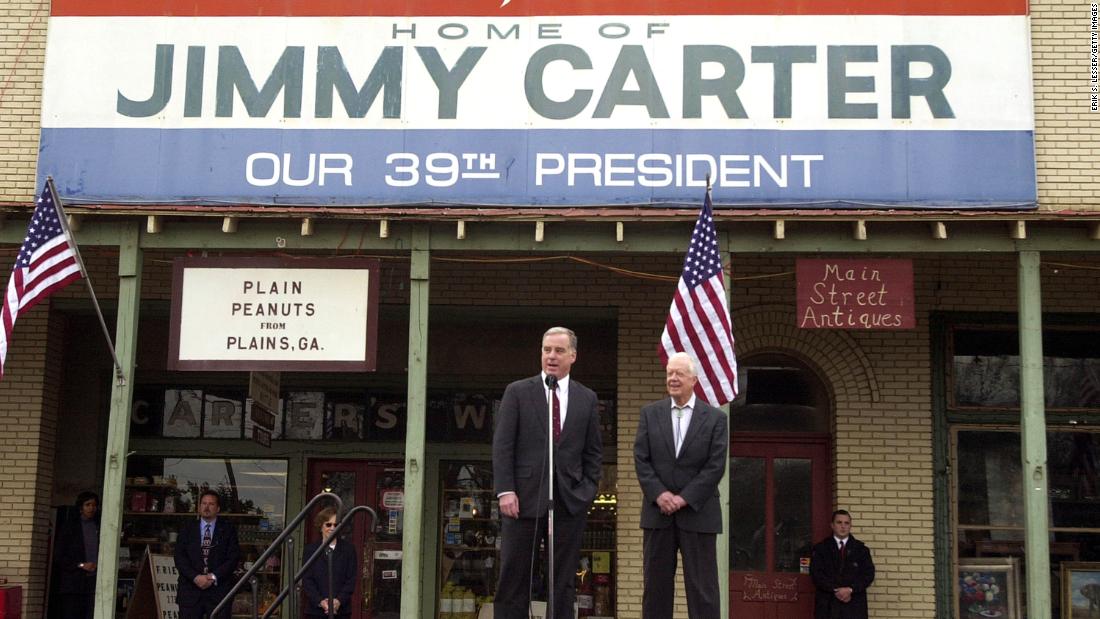 Democratic presidential candidate Howard Dean speaks beside Carter during a campaign stop in Plains, Georgia, in January 2004.