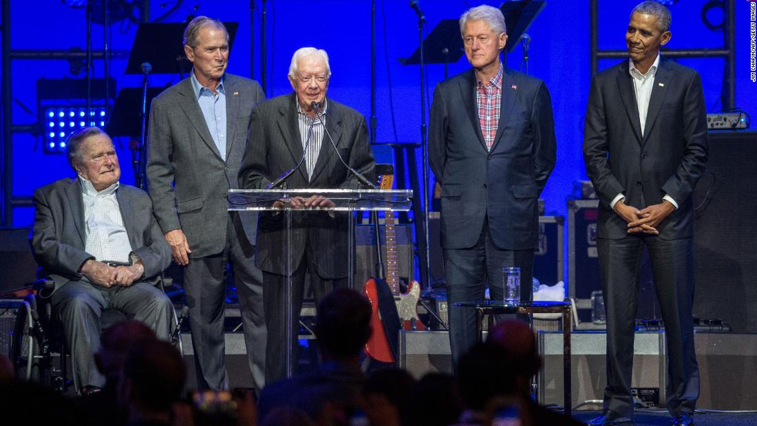 Carter, center, speaks along side former US Presidents George H. W. Bush, George W. Bush, Bill Clinton and Barack Obama as they attend the Hurricane Relief concert in College Station, Texas, in October 2017.