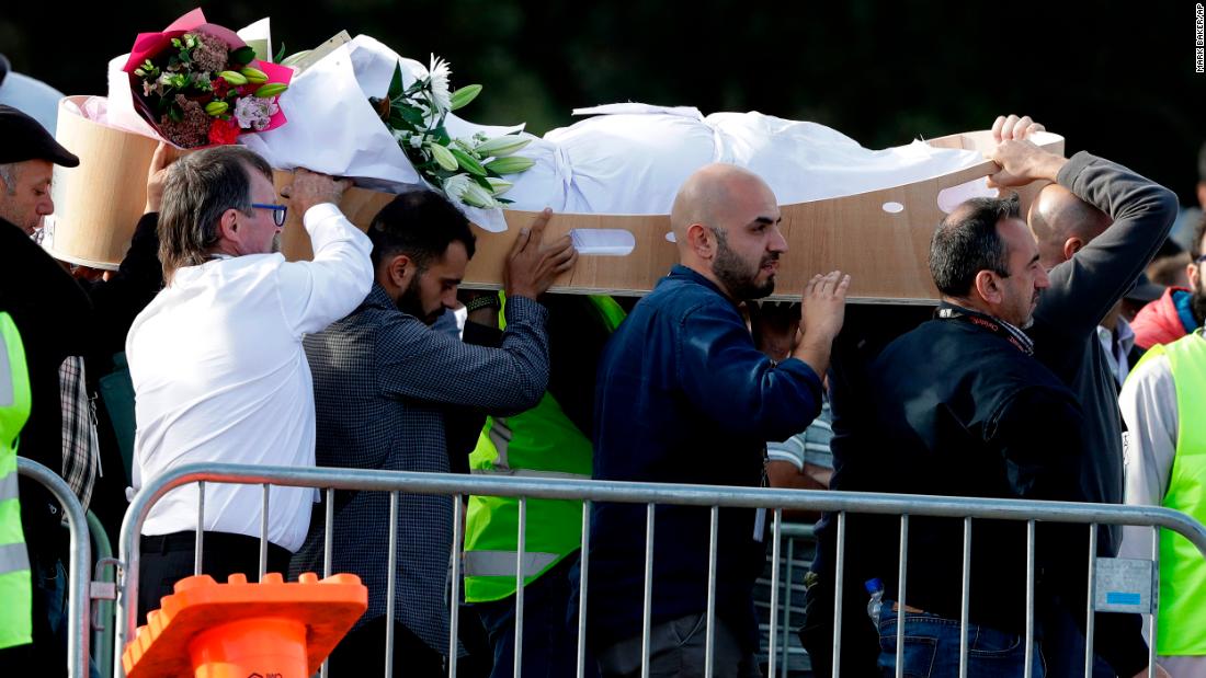 Mourners carry a body at Memorial Park Cemetery in Christchurch on March 22 as funerals continued a week after the deadly attacks.