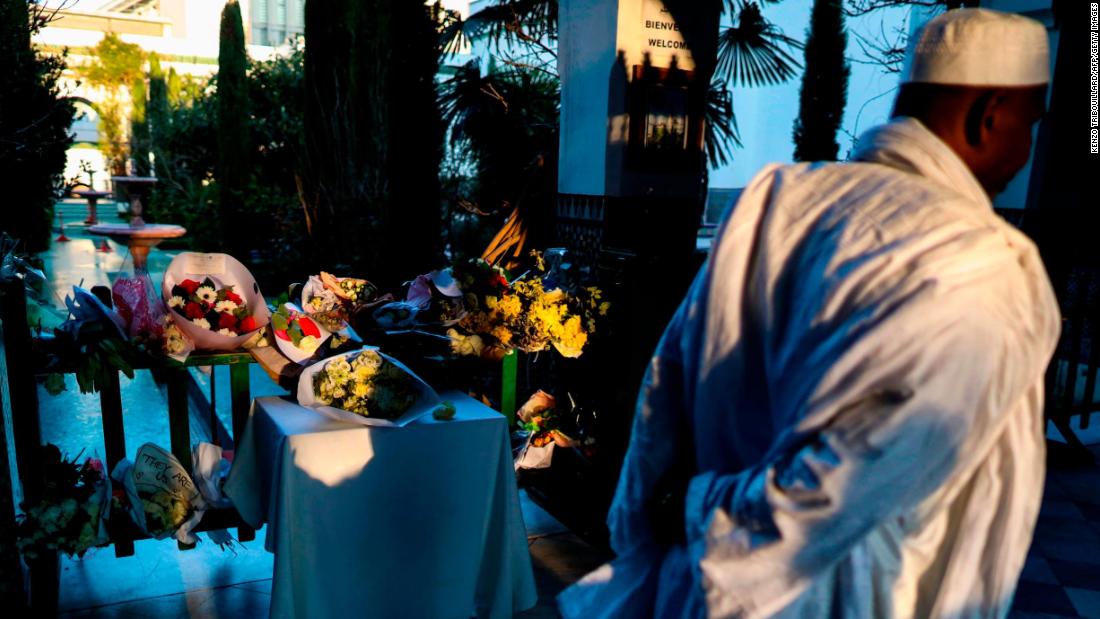 A man passes a makeshift memorial for the New Zealand victims at the Great Mosque of Paris on Friday, March 22.