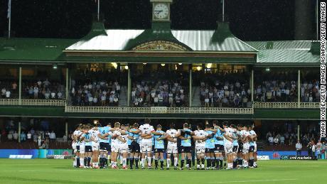 Crusaders and Waratahs players form a huddle before their Super Rugby game