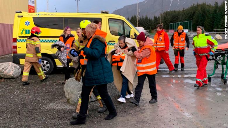 Rescued passengers are helped from a helicopter.