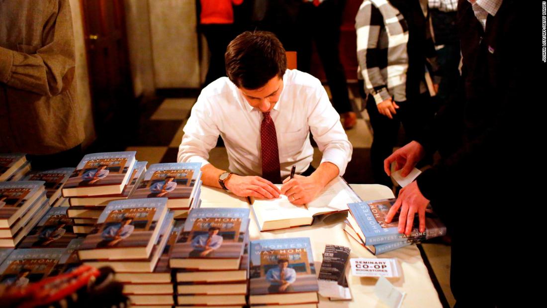 Buttigieg signs copies of his book &quot;Shortest Way Home&quot; in February 2019.