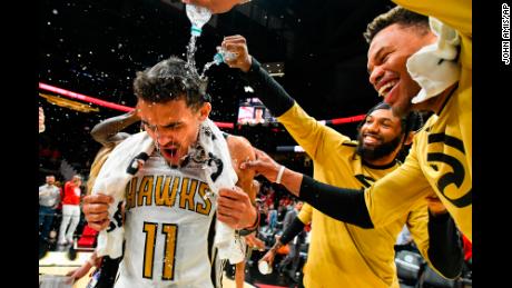 Trae Young (11) is doused by Atlanta Hawks teammates.