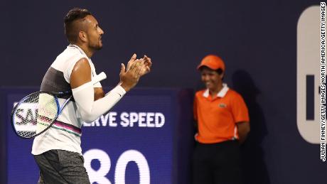 Kyrgios claps as the fan is shown off the court