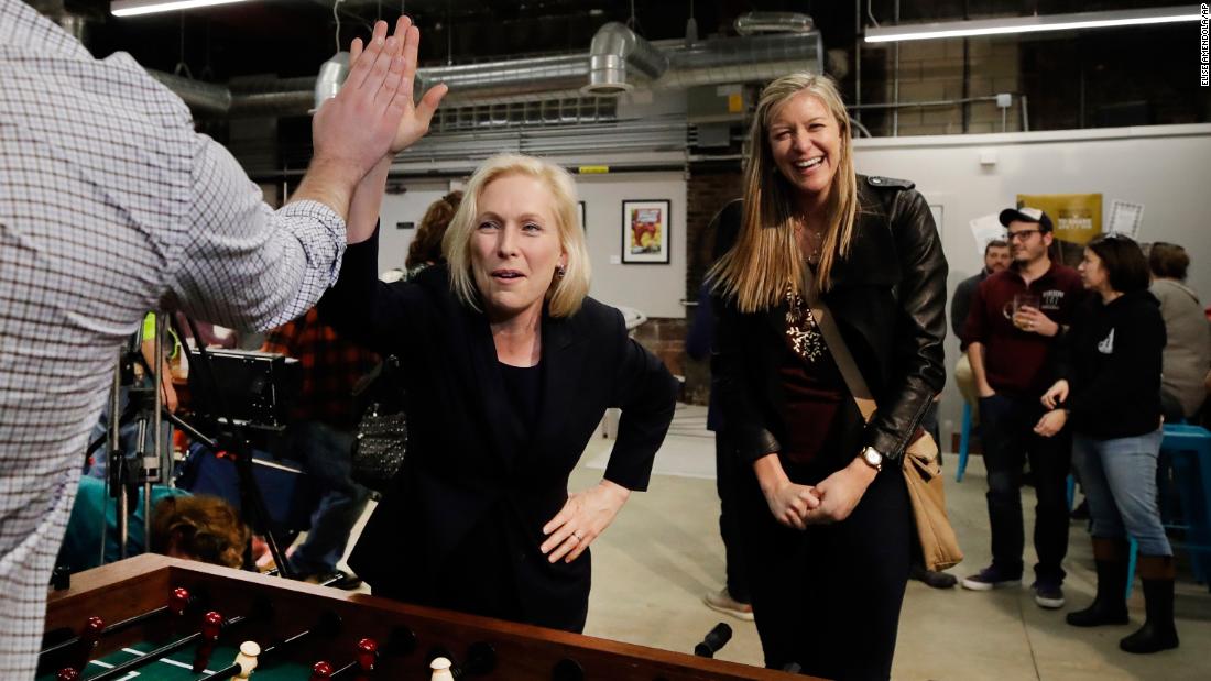 Gillibrand high-fives a foosball opponent while campaigning in Manchester, New Hampshire, in March 2019.