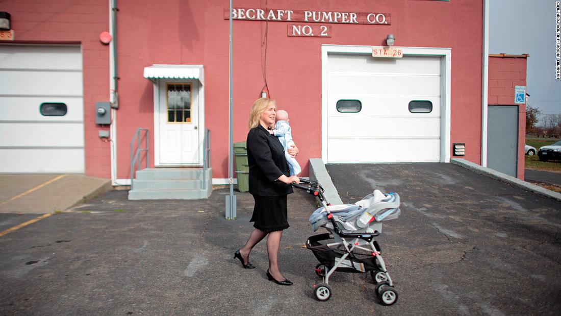 Gillibrand walks with her infant son, Henry, after voting in Greenport, New York, in 2008. She has two sons with her husband, Jonathan.