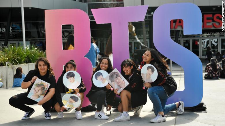 Fans pose outside a BTS concert at the Staples Center in Los Angeles in September 2018. 