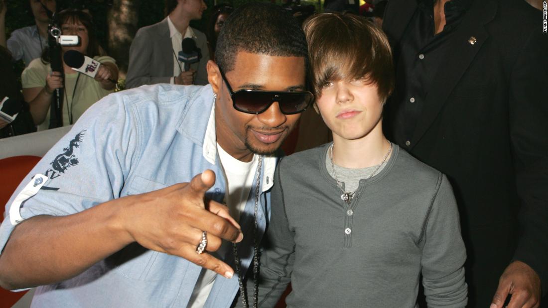 Bieber and R&amp;amp;B singer Usher attend the Kids&#39; Choice Awards in March 2009. Bieber auditioned for Usher in 2008 and soon got a record deal.