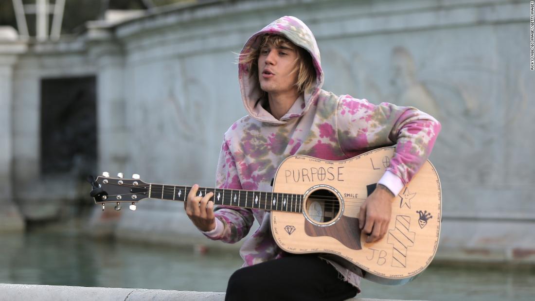 Bieber plays a guitar outside Buckingham Palace in London in September 2018. &lt;a href=&quot;https://www.cnn.com/2018/09/19/entertainment/justin-bieber-hailey-baldwin-london-surprise-trip-intl/index.html&quot; target=&quot;_blank&quot;&gt;The unexpected performance&lt;/a&gt; came while Bieber and Baldwin were out sightseeing. A small crowd gathered to watch his short acoustic set.