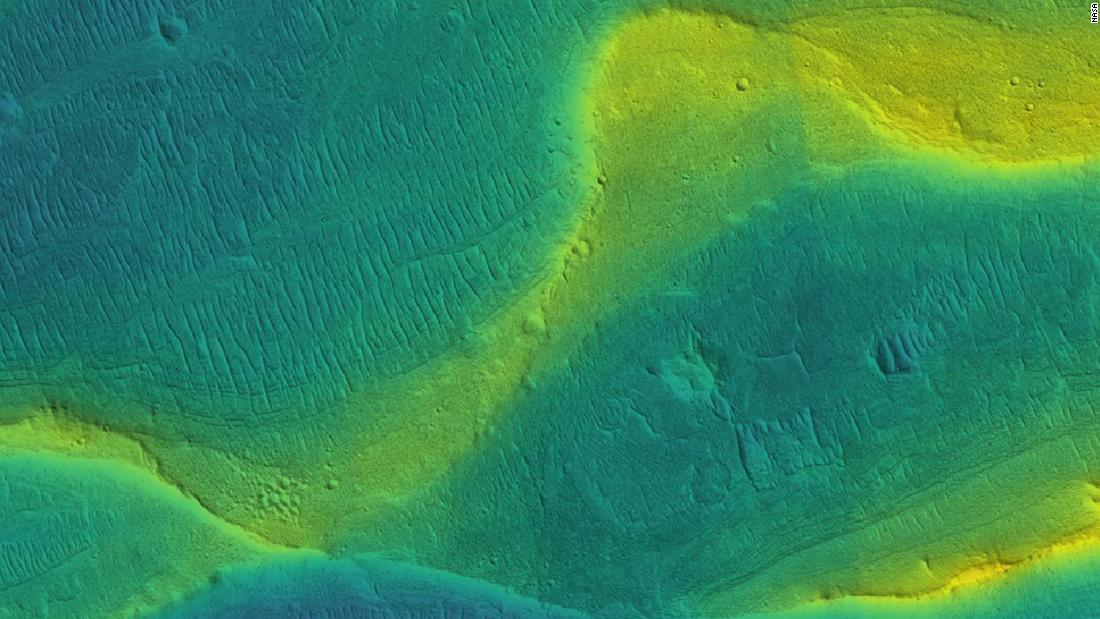 A photo of a preserved river channel on Mars, taken by an orbiting satellite, with color overlaid to show different elevations. Blue is low and yellow is high.