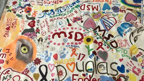 Students from Marjory Stoneman Douglas created a canvas mural at the library on the anniversary of the mass shooting.