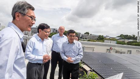 Visitors view the so-called &quot;solar farm&quot; on the building&#39;s roof, which contains over 1,200 panels. 