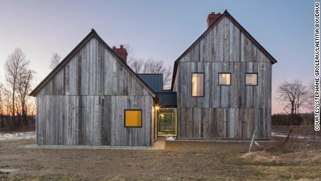 The home is clad in salvaged barn wood to give it a uniform weathered look.