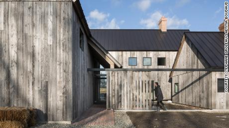 The new construction barn-inspired home features three connected buildings around a courtyard.