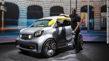 A worker cleans a Smart Forease electric concept at the Geneva Auto Show in March.